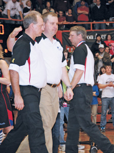 COACH ROB Baruth pats his co-head coach Tim McCain on the back as they go to receive the Runner-Up trophy. Asst. Coach Justin Dean returns to his team after receiving his medal.