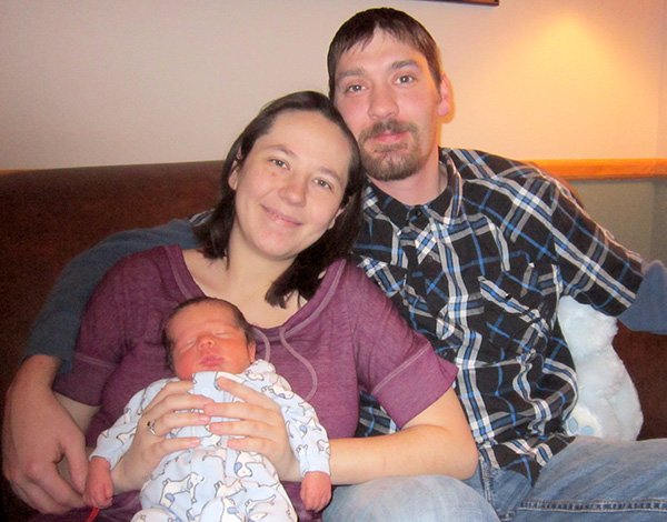 Lucas Eugene Novak, HRMC’s 2016 First Baby of the New Year, sleeps peacefully in the arms of his parents, Jen Gibson and Matt Novak of Woonsocket.