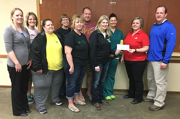 Sanborn County 4-H gratefully accepts a $2,000 Working Here Fund Grant from Farm Credit Services of America.  Pictured are Angie Fridley, Roxann Larson, Velma Kneen, Janet Maeschen, Stacy Zoss, Steve Zoss, Paula Linke and Sarah Olinger receiving the check from FCSAmerica representatives Tambi Wormstadt and Kevin Haber.