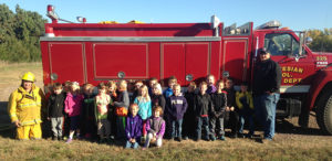 Firefighters from the Artesian Fire Department visited at Sanborn Central School to kick off Fire Prevention Week. Kasey Bechen and Michael Morgan talked to the students in grades Pre-K through fifth. Ryan Bechen and Travis King showed the firetruck to the students and allowed them to man the hoses. At right, Artesian volunteer fireman Ryan Bechen helps Carley Edwards man a fire hose.