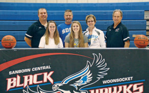 MYAH SELLAND smiles with her parents and coaches after signing her letter of intent to play for the Division I SDSU Jackrabbits next fall. Left to right are coaches Rob Baruth and Emily Olson, her father, Brett Selland, Myah, her mother, Kelly Selland and Coach Tim McCain.