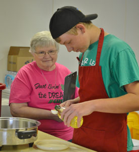 Nathan Linke measures one of his ingredients in front of the judge, Margo Edwards, during the Special Foods Contest.